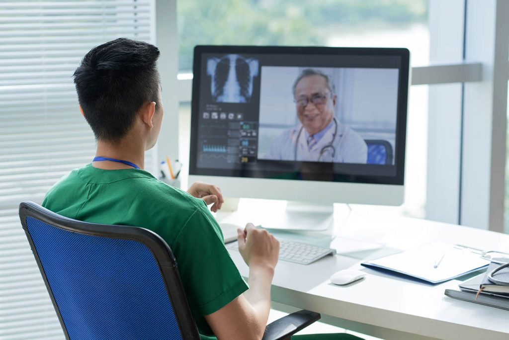 nhs healthcare worker using computer for video conference
